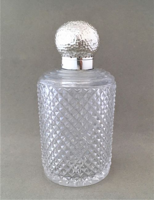 An Arts & Crafts Inspired Silver Mounted Cologne Bottle