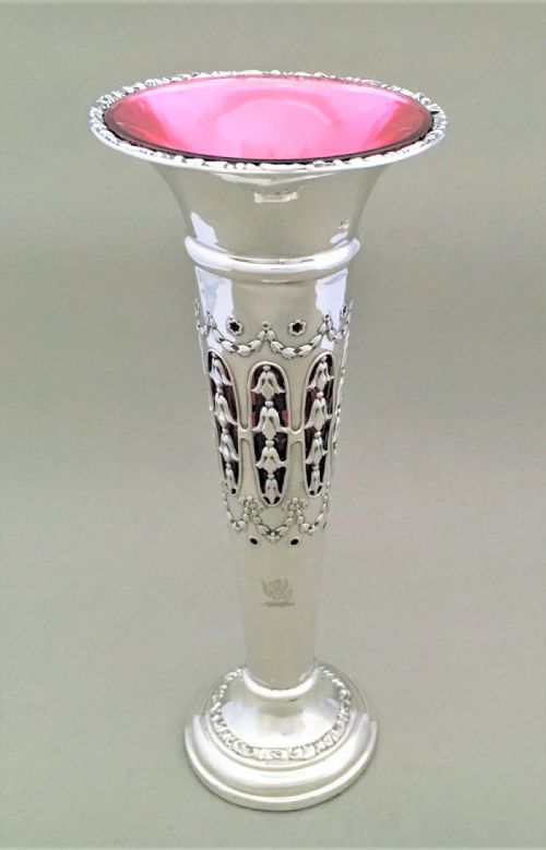 A Stunning Silver and Cranberry Pierced Trumpet Vase