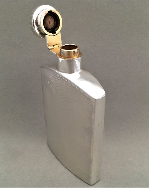 fig 1. A silver hip flask with engine turned panels