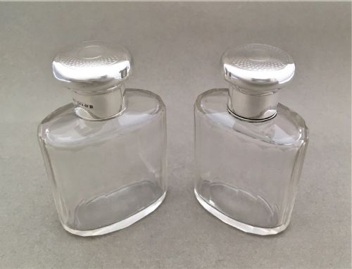 A Charming Pair of Silver Mounted Cologne Bottles