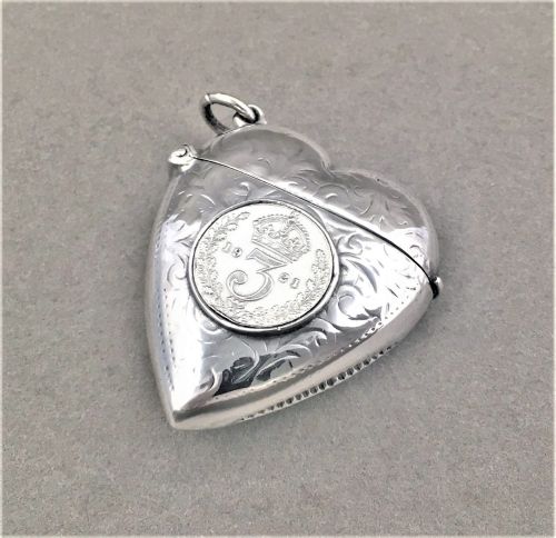 fig 1. A sterling silver heart shaped Vesta with threepenny bit