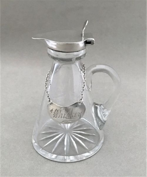 A Silver Mounted 'Whiskey' Tot with Silver Label
