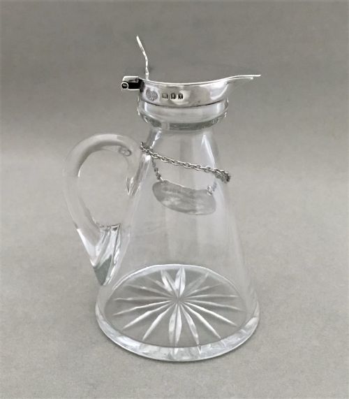 fig 1. A Silver mounted 'Whiskey' tot with silver label