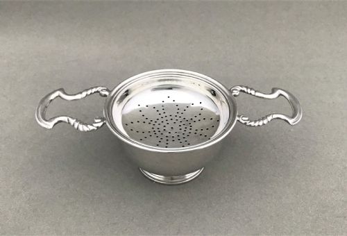 A Charming Silver Tea Strainer & Drip Cup
