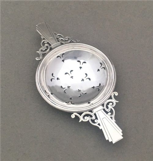 fig 1. A handsome Art Deco silver tea strainer
