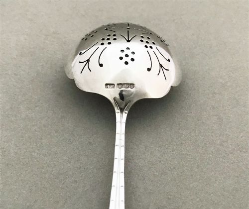fig 1. An Art Deco period silver tea strainer