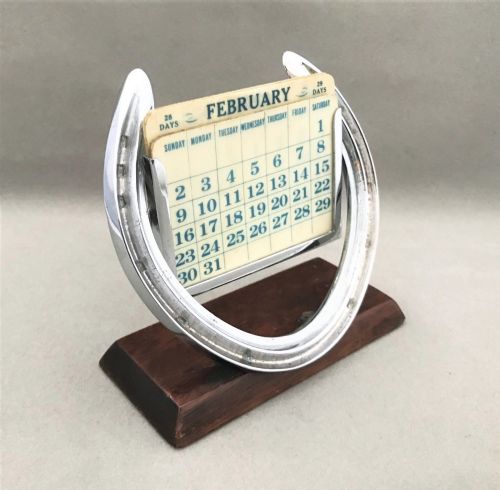An Edwardian Lucky Horse Shoe Plated Perpetual Calendar