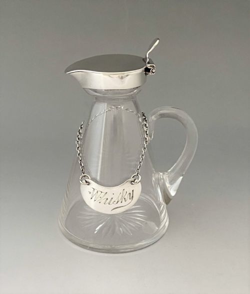 An Asprey Silver Mounted Whisky Tot with Silver Label