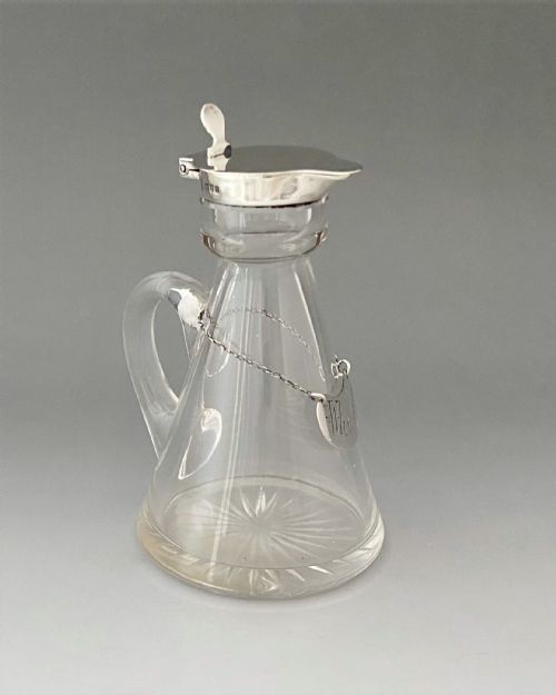 fig 1. A superb silver mounted Whisky tot and matching silver label