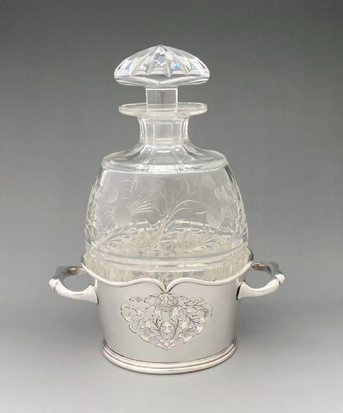 A Fabulous Cut Glass Decanter with Silver Plated Holder