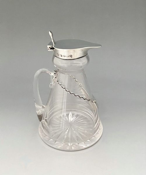 fig 1. A fine silver mounted Whisky tot with original matching silver label