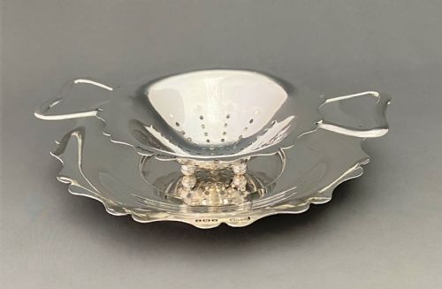 fig 1. A stylish silver tea strainer & matching drip cup