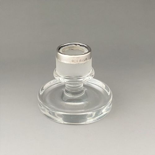 fig 1. An Edwardian clear glass match striker featuring a tray base, a frosted striking column, and a hallmarked sterling silver rim holding matches.