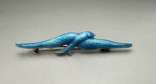 A WONDERFUL SILVER BLUE GUILLOCHE ENAMEL SWIFT BROOCH