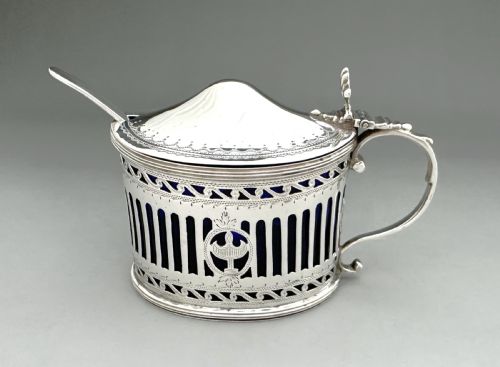 fig 1. Victorian pierced sterling silver mustard pot with a domed hinged lid, scroll handle, and cobalt blue glass liner.