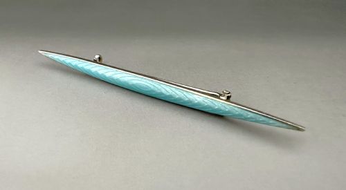 fig 1. A slender Norwegian sterling silver bar brooch featuring light turquoise guilloche vitreous enamel over an engine-turned pattern.