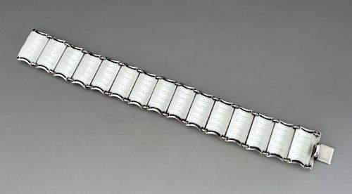 fig 1. A Scandinavian sterling silver panel bracelet decorated with white guilloche enamel and dark contrasting borders.