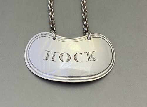 fig 1. A Georgian sterling silver decanter label engraved with the word HOCK suspended from a fine silver chain.