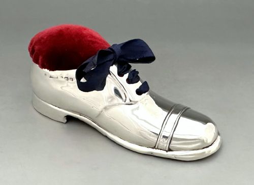 A delightful Edwardian silver shoe pin cushion