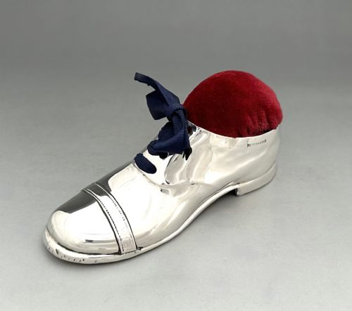 fig 1. An Edwardian sterling silver pin cushion crafted in the shape of a lace-up shoe with a red velvet cushion top.