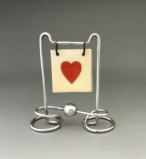 A DELIGHTFUL SILVER PLATED TRUMP MARKER