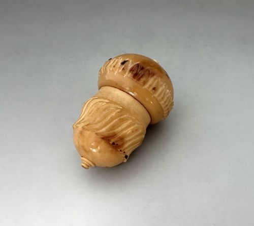 A COROZO NUT THIMBLE CASE WITH SILVER THIMBLE