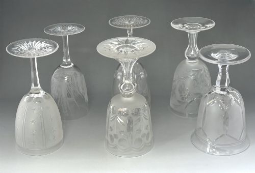 fig 1. A set of six clear Victorian glass goblets, each featuring distinct hand-etched and cut geometric and floral patterns.