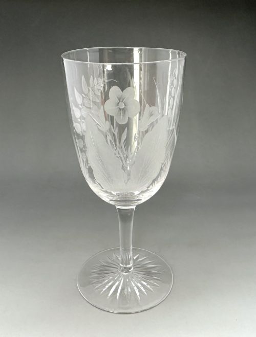 fig 4. A set of six clear Victorian glass goblets, each featuring distinct hand-etched and cut geometric and floral patterns.