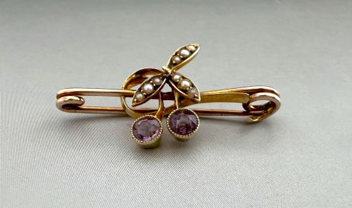 fig 1. Victorian 9ct gold bar brooch featuring a central cherry motif with seed pearl leaves and two faceted pink gemstones.