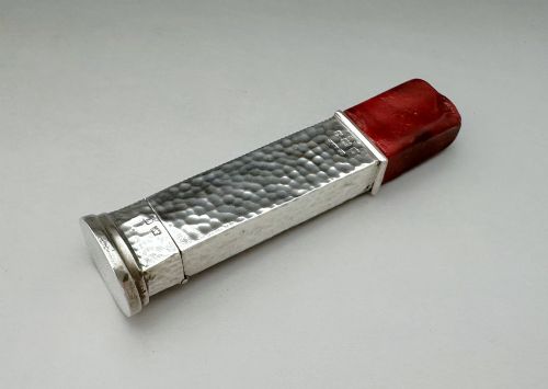 fig 1. An Edwardian sterling silver vesta case with a hand-hammered finish and ribbed sides, fitted with a stick of red sealing wax.