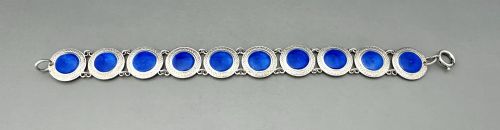 fig 1. An Art Deco silver link bracelet featuring circular panels filled with cobalt blue guilloche enamel.