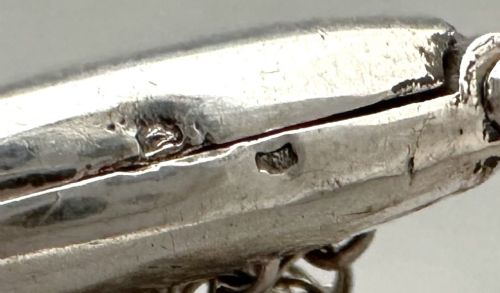 A petite French silver chainmail purse featuring a curved kiss-clasp frame and small silver spherical drops attached along the bottom seam. View V