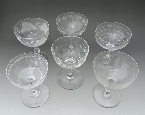 fig 1. A harlequin set of six antique clear glass champagne coupes featuring various hand-etched geometric and floral patterns.