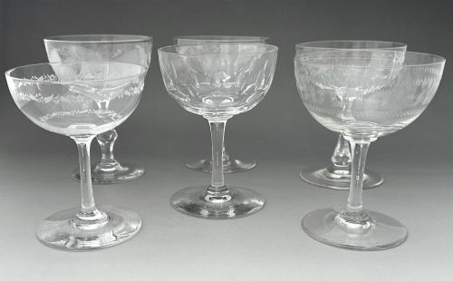 fig 2. A harlequin set of six antique clear glass champagne coupes featuring various hand-etched geometric and floral patterns.