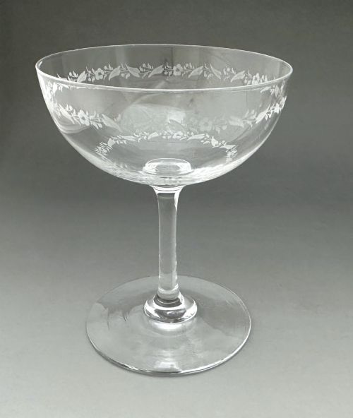 fig 3. A harlequin set of six antique clear glass champagne coupes featuring various hand-etched geometric and floral patterns.