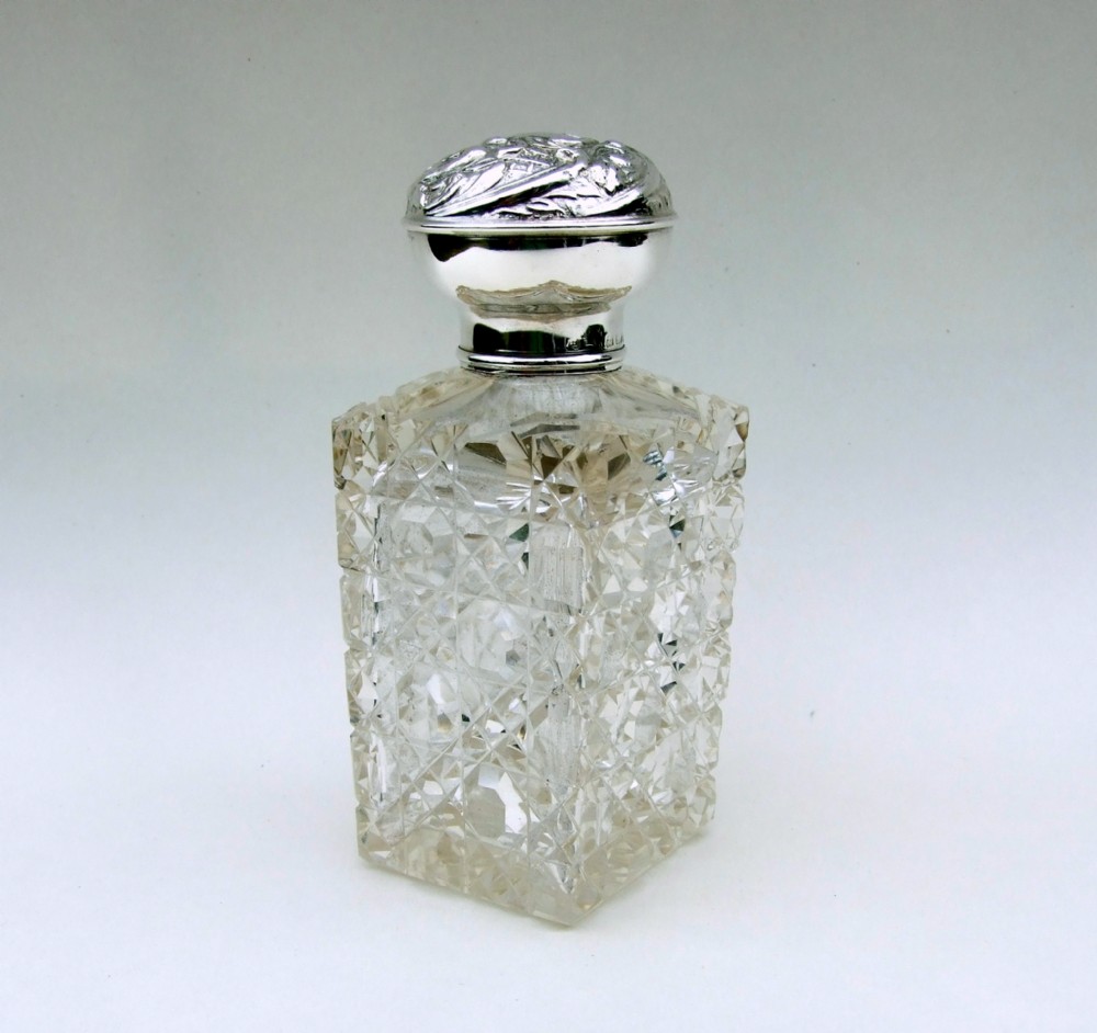 A lovely Edwardian silver mounted cologne bottle