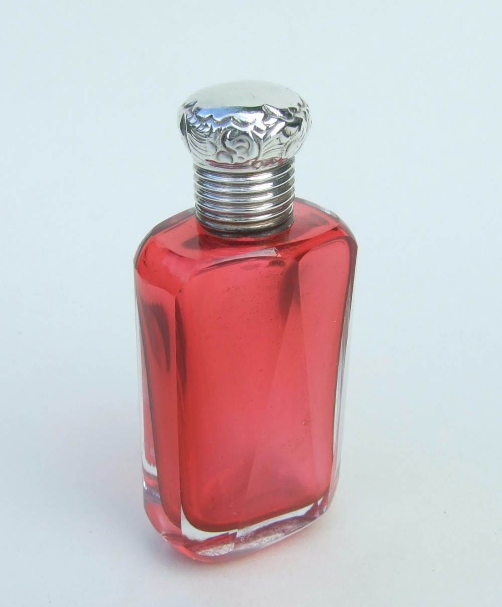A delightful silver mounted cranberry perfume bottle from the late Victorian period.