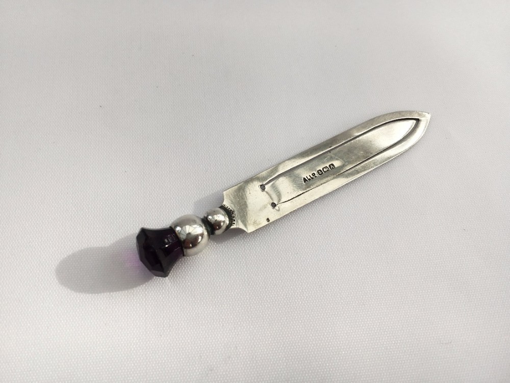 A silver bookmark with amethyst thistle finial.