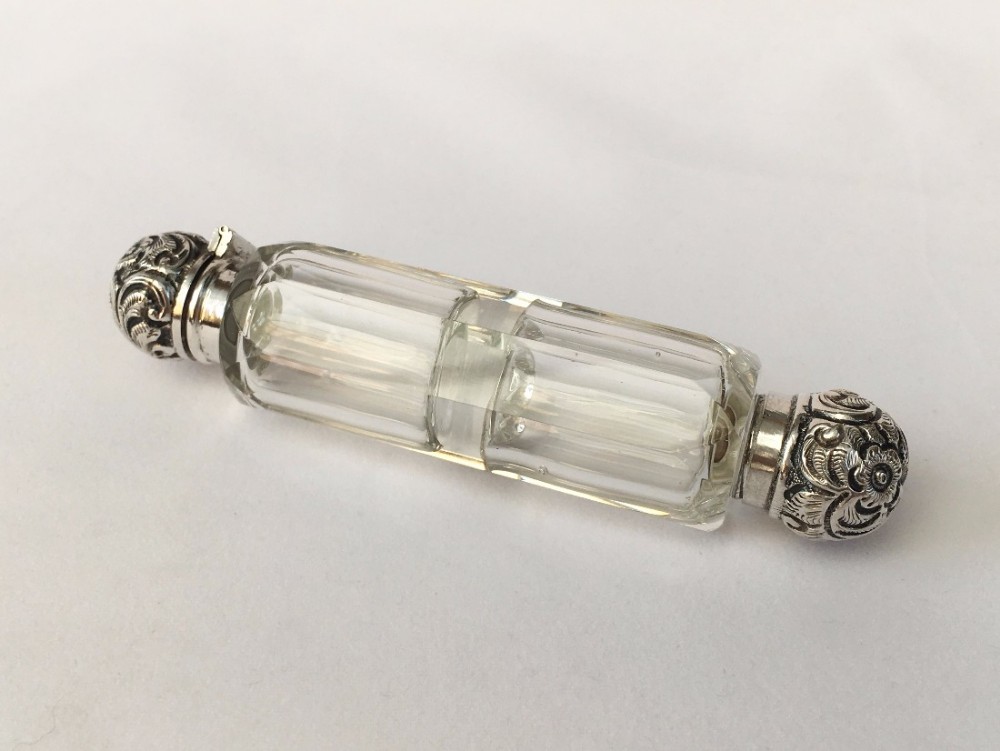 An unusual Victorian double ended perfume bottle with silver mounts.