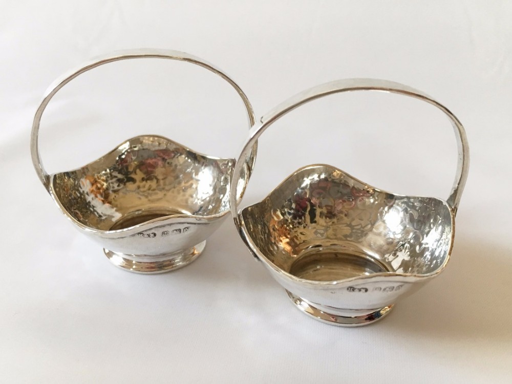 A pair of Arts & Crafts silver sweetmeat baskets.