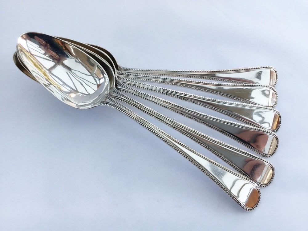A set of six George III bead pattern dessert spoons.