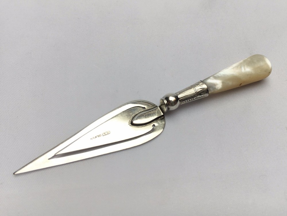 A large silver & mother-of-pearl bookmark.