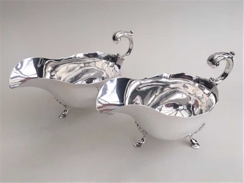 An impressive matching pair of silver gravy boats.