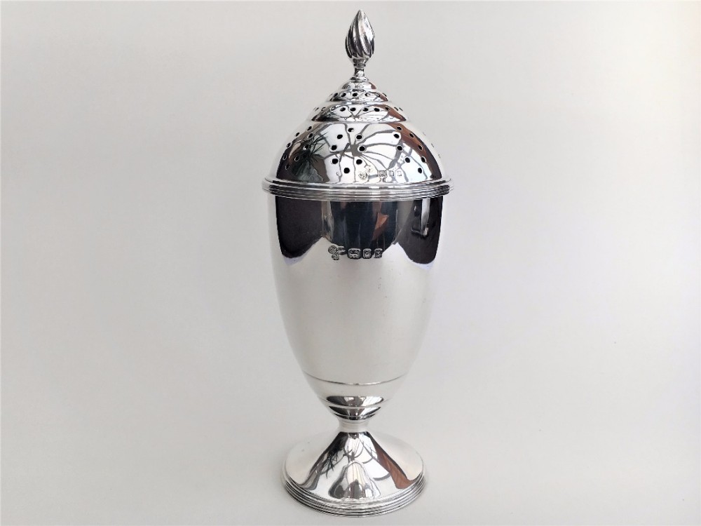 A Large Harrods silver sugar caster.