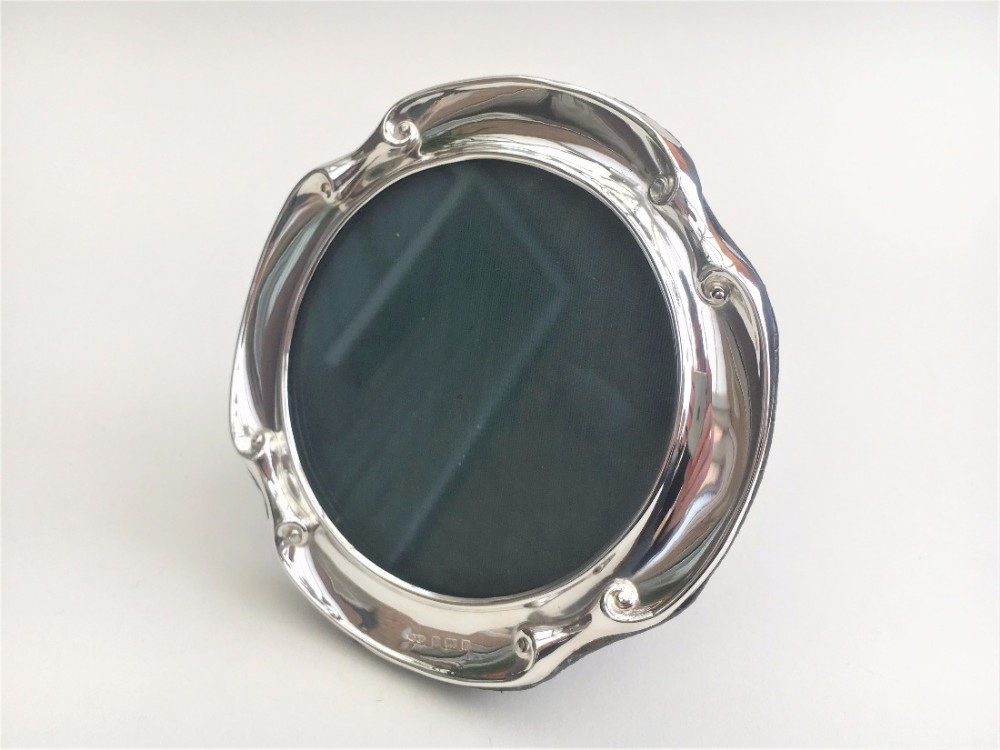 A Circular Victorian silver photo frame.