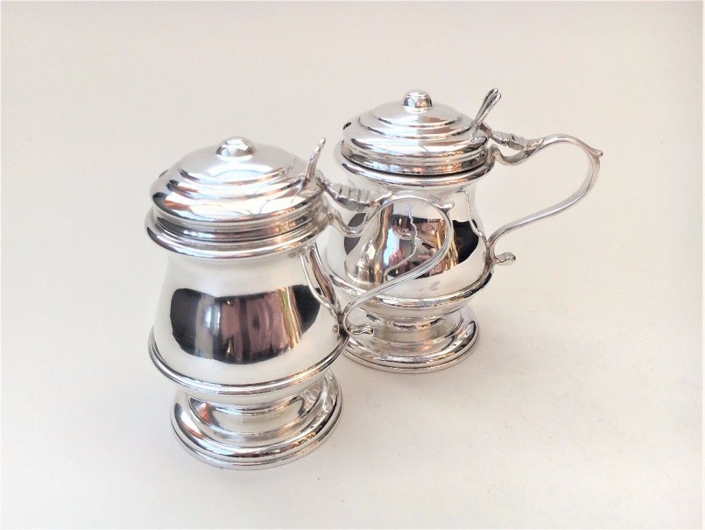 A handsome pair of baluster shaped silver mustard pots.