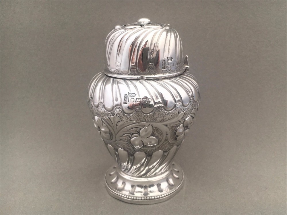 A fabulous Victorian repoussé Silver Caster.