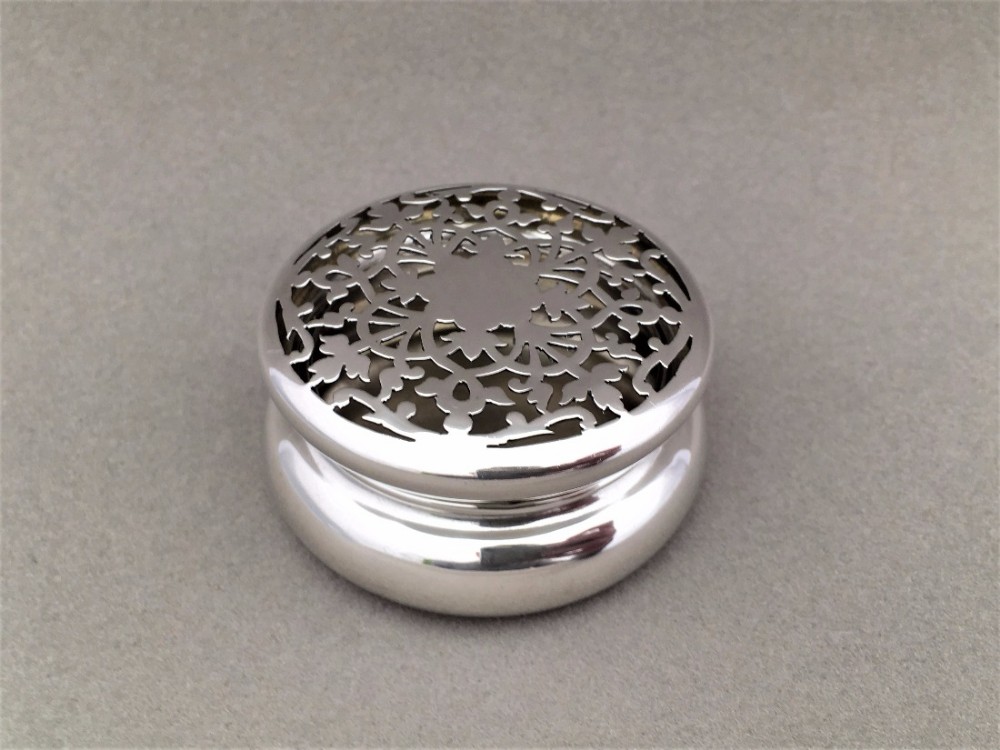A charming pierced silver pot pourri pot.