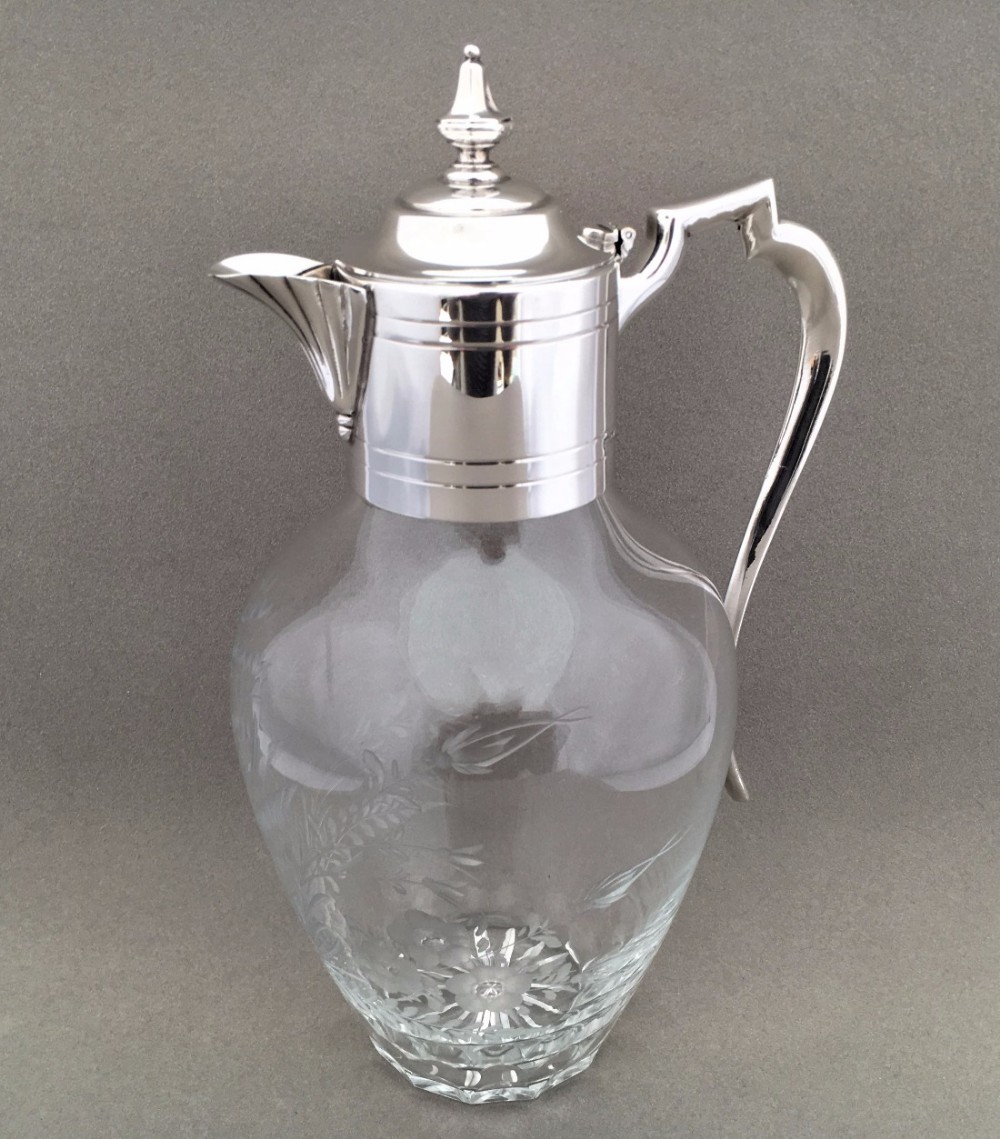 A Stunning late Victorian bird engraved silver plated claret jug.