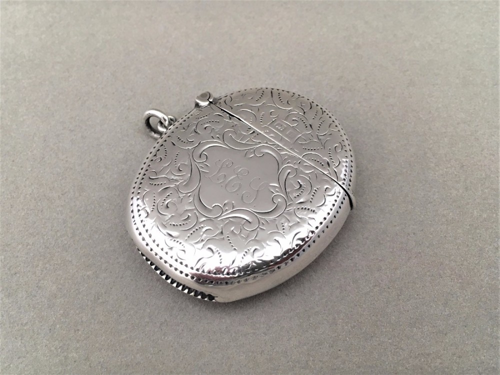 An unusual oval Edwardian silver vesta.